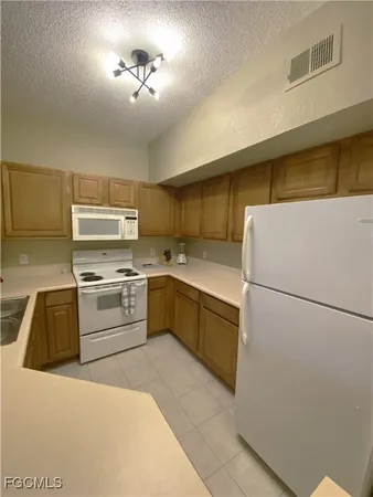 a kitchen with a refrigerator and a sink