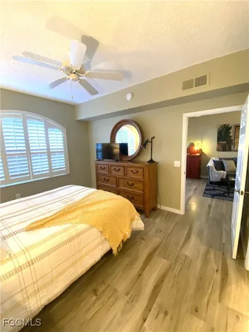 a bedroom with a bed and a large mirror