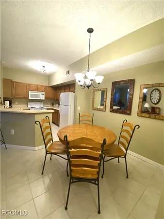 a view of a dining room with furniture and chandelier