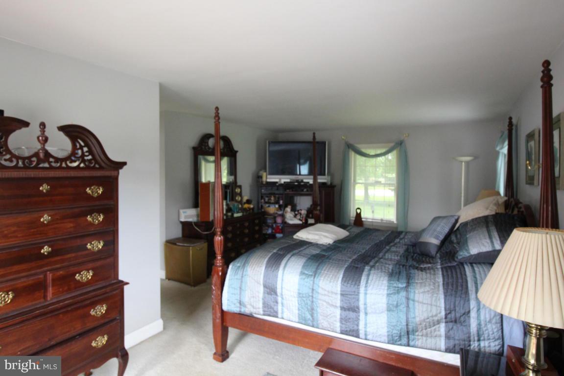 546 Koser Road Lititz, PA 17543 - Photo 13 of 30 a bedroom with a bed and wooden floor