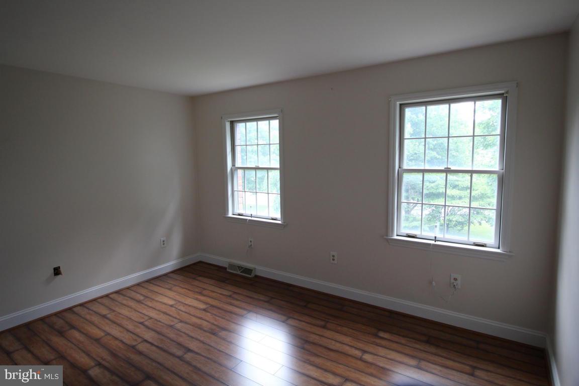 546 Koser Road Lititz, PA 17543 - Photo 14 of 30 a view of an empty room with wooden floor and a window
