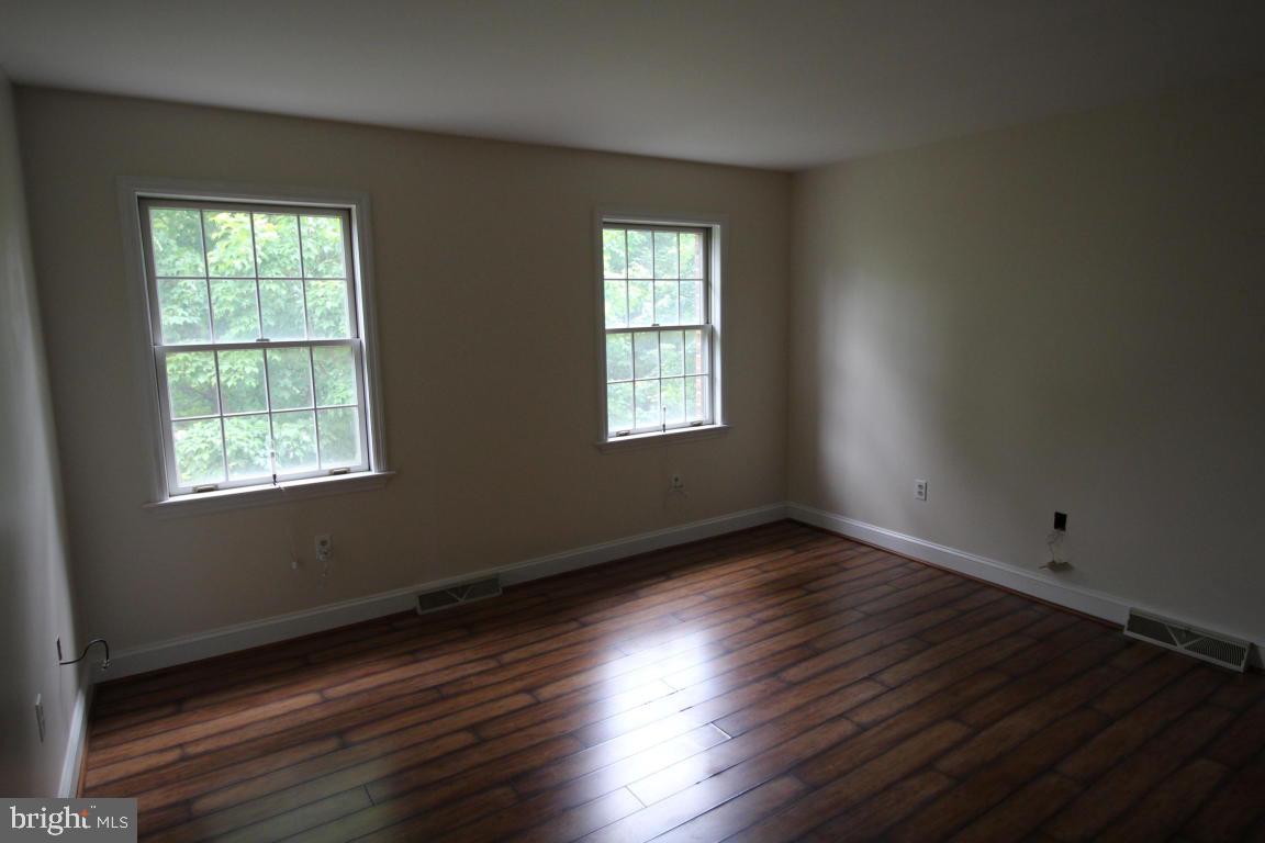 546 Koser Road Lititz, PA 17543 - Photo 21 of 30 an empty room with wooden floor and windows