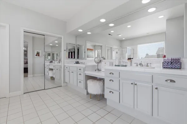 a kitchen with white cabinets appliances and a sink