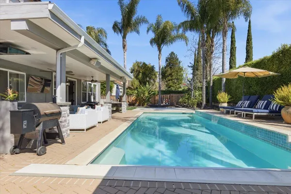 a view of a backyard with swimming pool