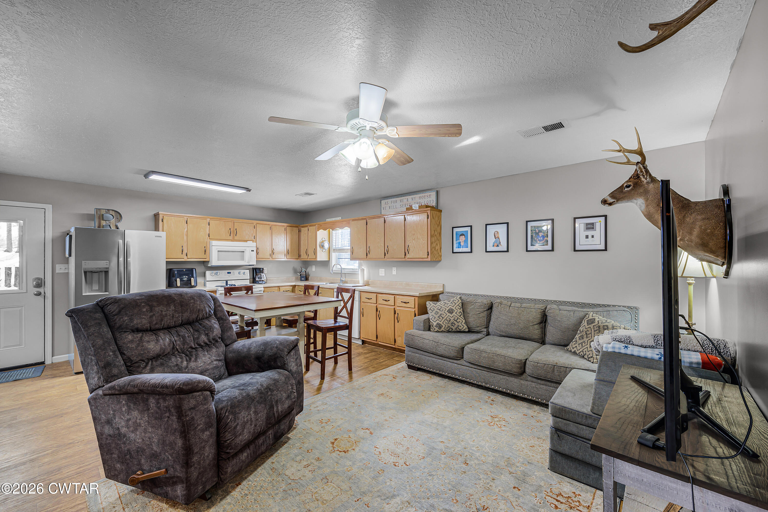67 Robert Crocker Road Bradford, TN 38316 - Photo 2 of 20 a living room with furniture and a flat screen tv with kitchen view