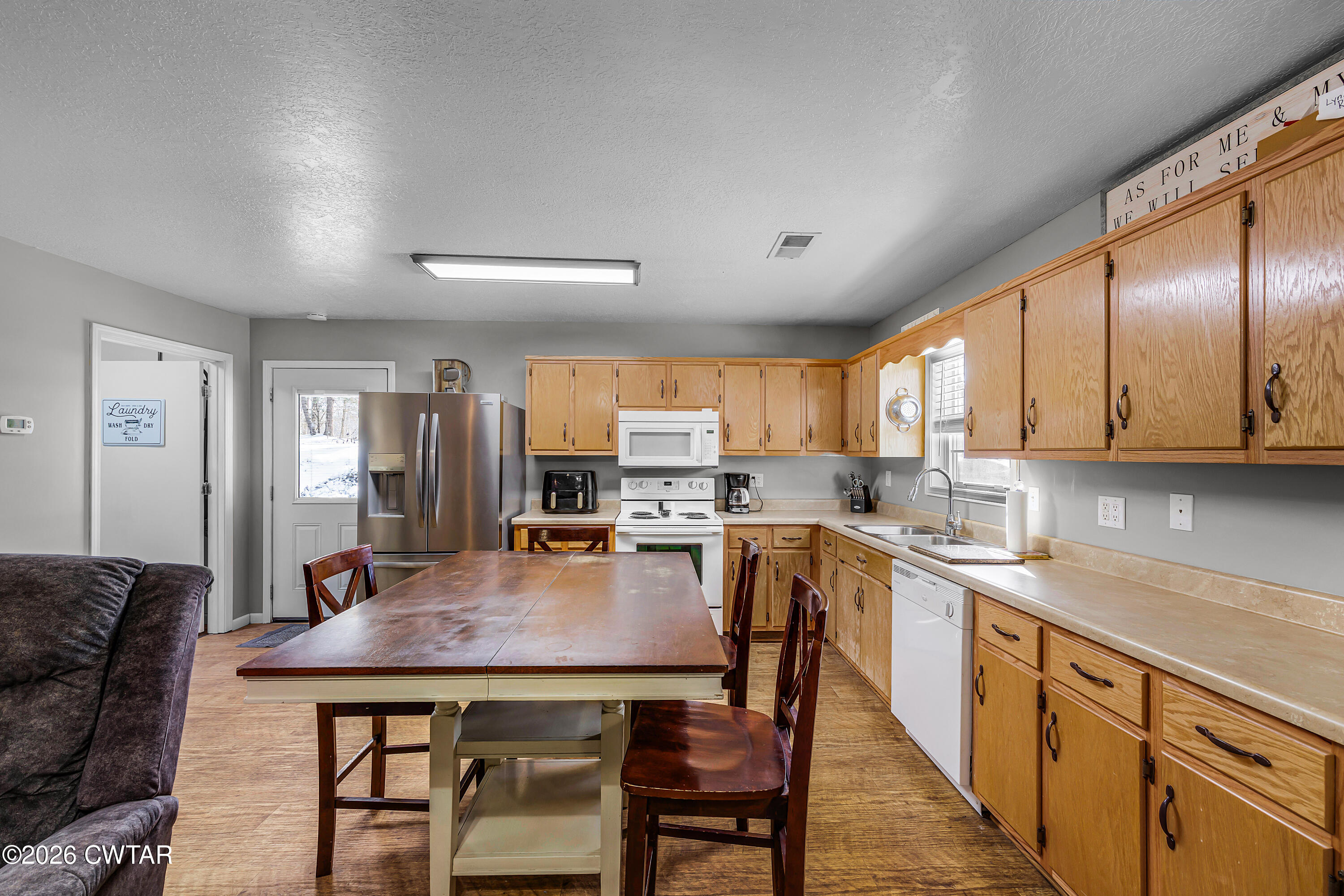 67 Robert Crocker Road Bradford, TN 38316 - Photo 7 of 20 a kitchen with a table chairs microwave and cabinets