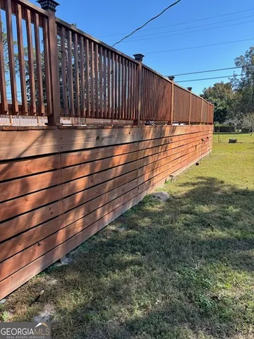 a view of a backyard with wooden fence