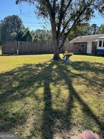 a swimming pool with an outdoor space and seating area
