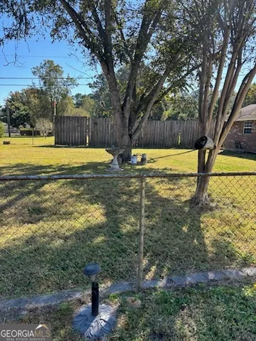 a view of a swimming pool with a yard