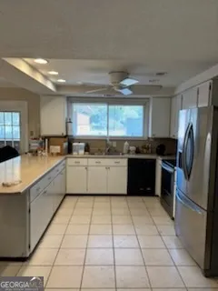 a large kitchen with stainless steel appliances granite countertop a stove a sink dishwasher and a refrigerator