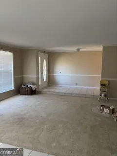 a view of a livingroom with a car parked on the road