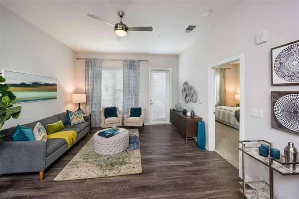a living room with furniture and wooden floor