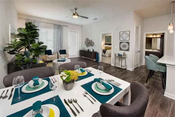 a living room with furniture and wooden floor