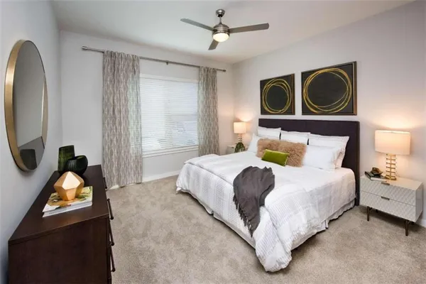 a bedroom with a bed dresser and a window