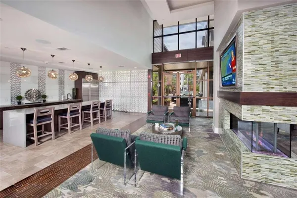 a living room with furniture wooden floor and windows