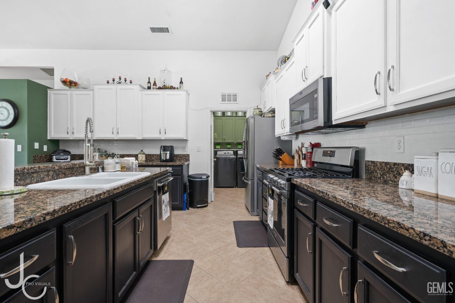 Undisclosed Address Bakersfield, CA 93312 - Photo 11 of 46 a kitchen with stainless steel appliances granite countertop a sink stove and refrigerator
