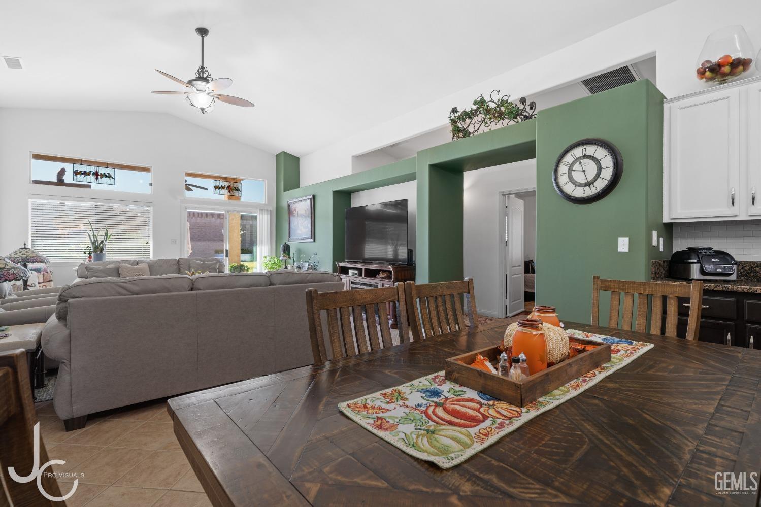 Undisclosed Address Bakersfield, CA 93312 - Photo 16 of 46 a living room with furniture and a clock
