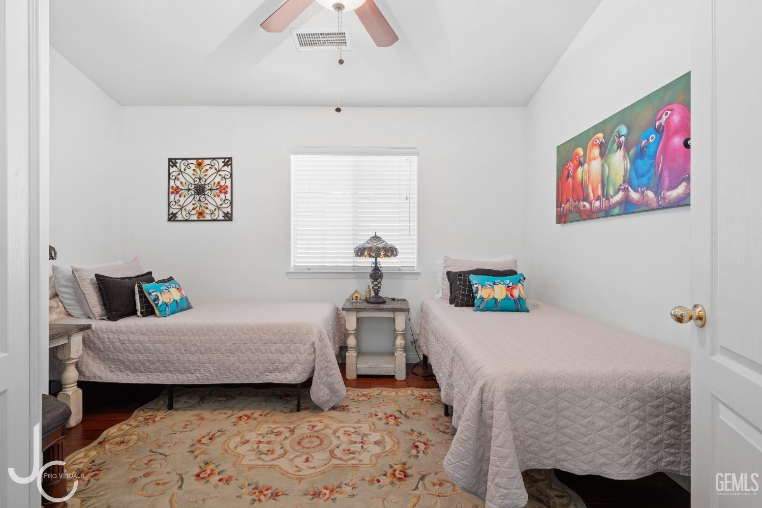 Undisclosed Address Bakersfield, CA 93312 - Photo 23 of 46 a bedroom with a bed and wooden floor