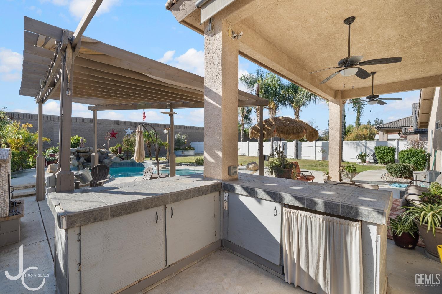Undisclosed Address Bakersfield, CA 93312 - Photo 33 of 46 a kitchen with stainless steel appliances granite countertop a sink and wooden cabinets