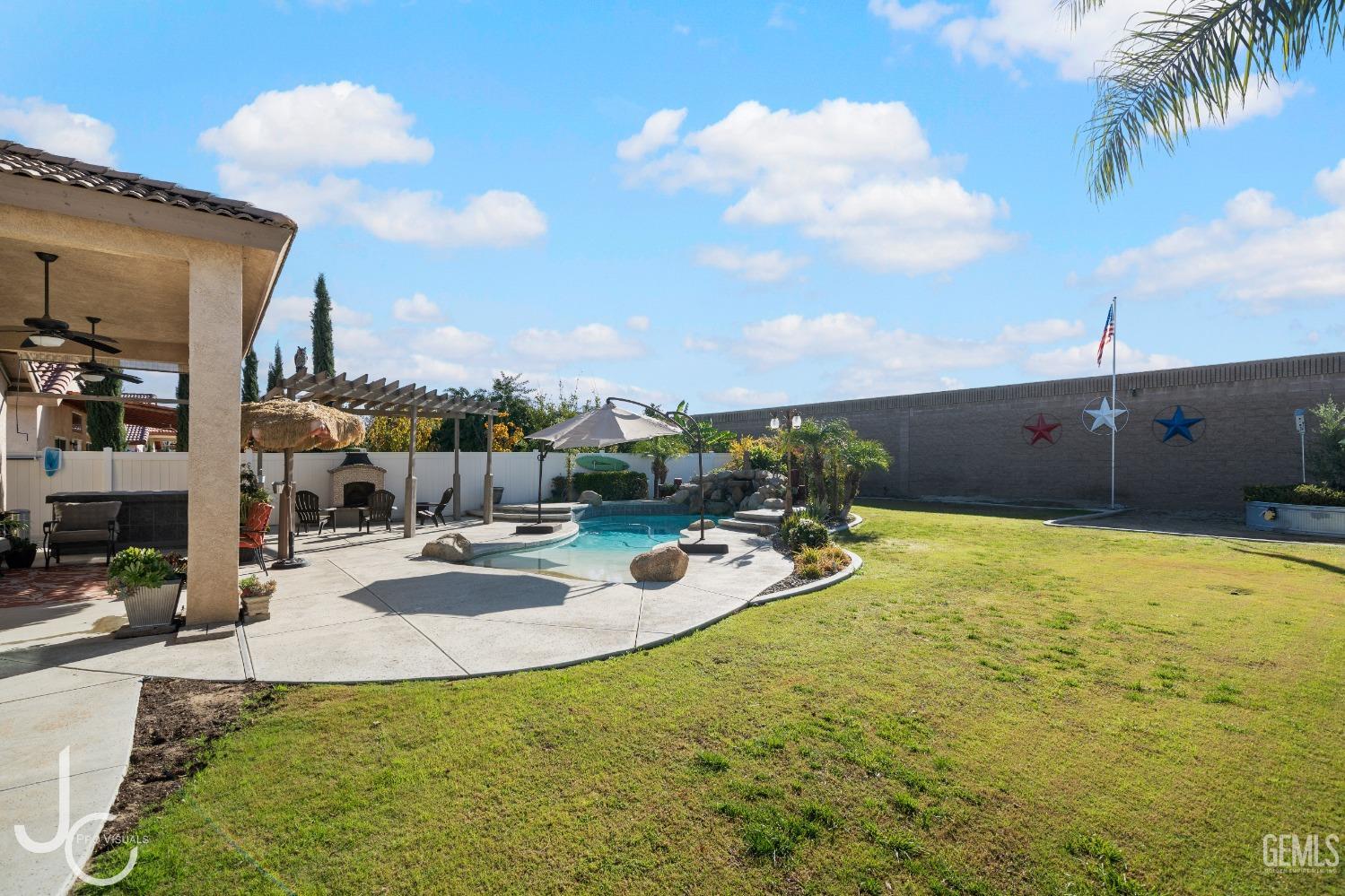 Undisclosed Address Bakersfield, CA 93312 - Photo 38 of 46 a view of a swimming pool with a yard