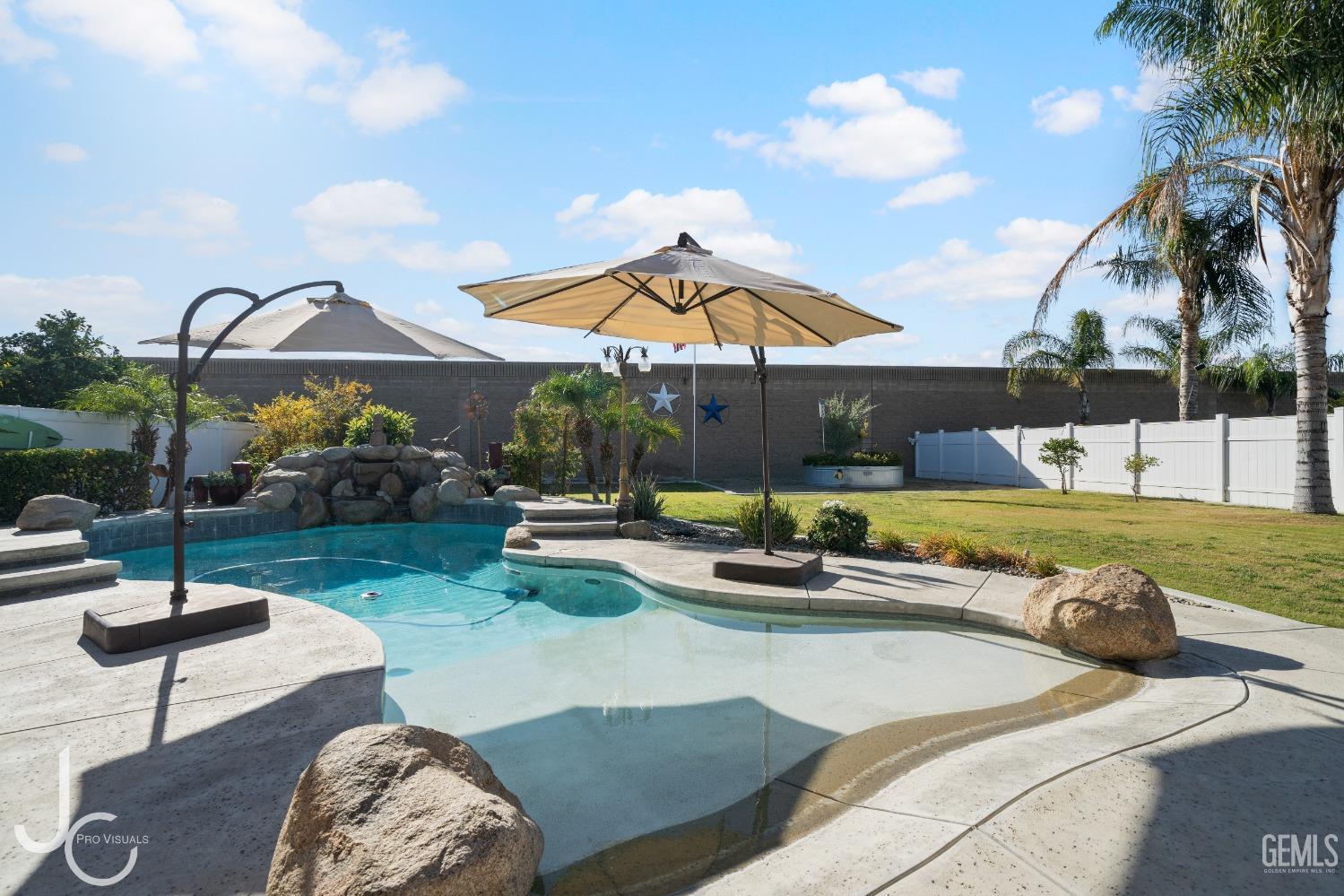 Undisclosed Address Bakersfield, CA 93312 - Photo 40 of 46 a view of a backyard with swimming pool and furniture