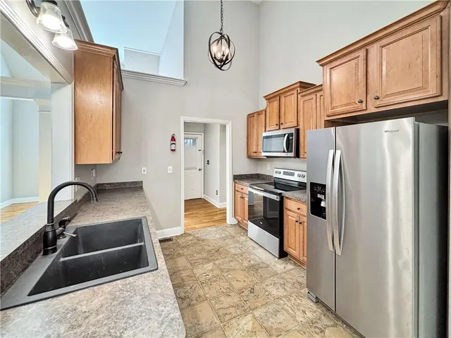 a view of a kitchen with wooden floor and a window