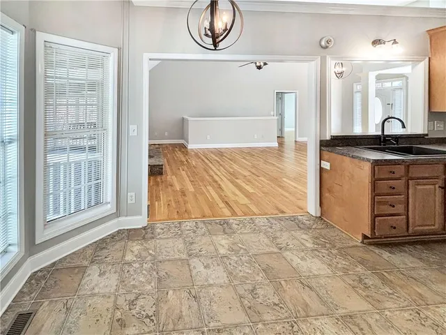 a bathroom with a granite countertop sink and a bathtub