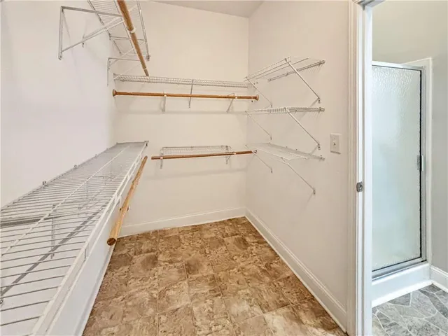 a view of an empty room with a window and a ceiling fan
