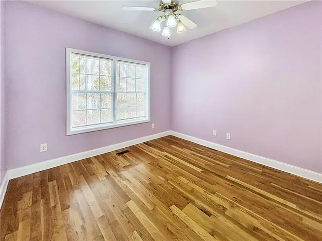 a bathroom with a sink a toilet a mirror and shower