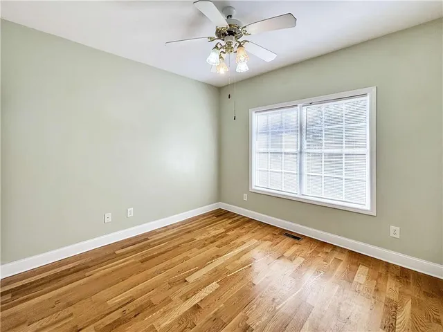 a view of a room with wooden floor