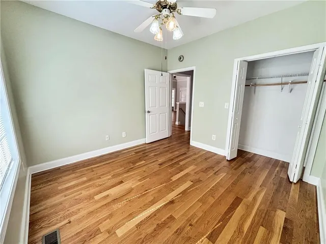 a view of room with wooden floor and entryway