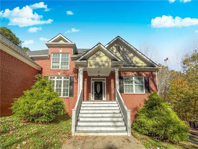 a view of a livingroom with wooden floor and door