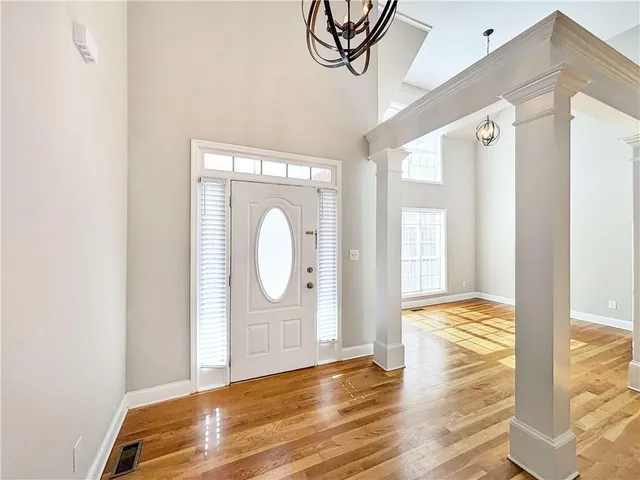 a spacious bedroom with a bed and a window