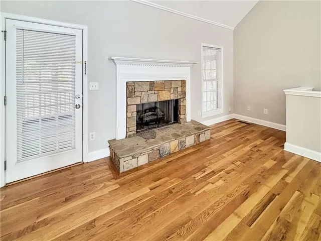 an empty room with wooden floor