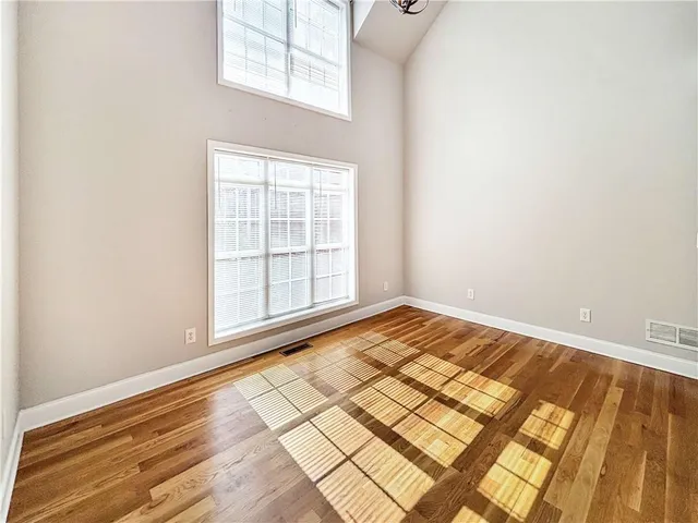 a kitchen with granite countertop a refrigerator a stove top oven and a sink