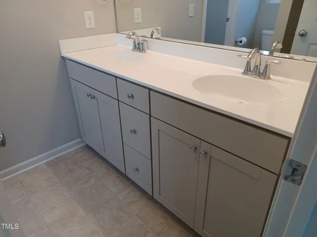 a white toilet sitting in a bathroom next to a window