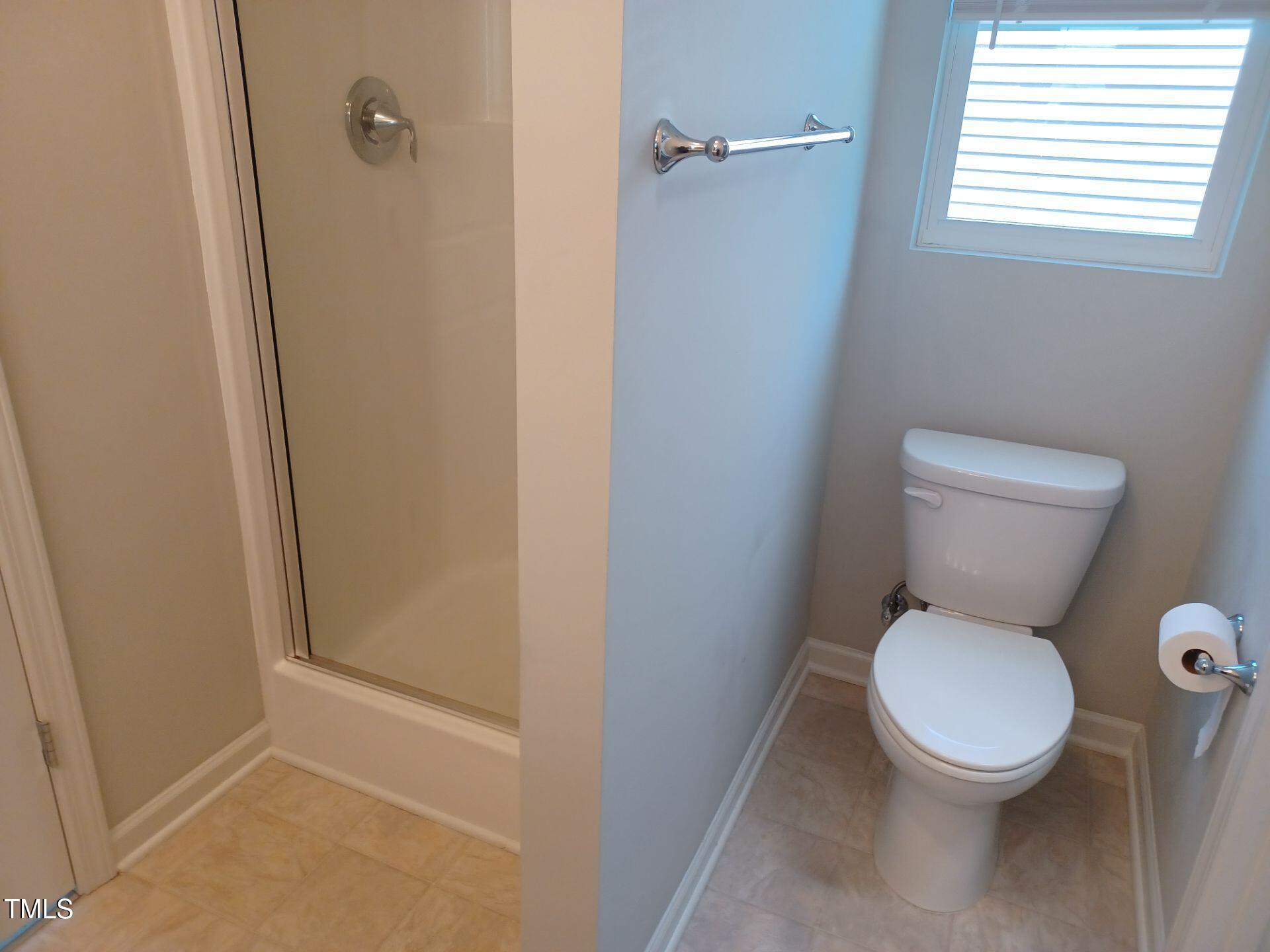 424 Cherry Street Fuquay-Varina, NC 27526 - Photo 15 of 28 a white toilet sitting in a bathroom next to a window
