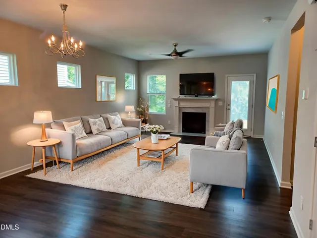 a living room with furniture a fireplace and a flat screen tv
