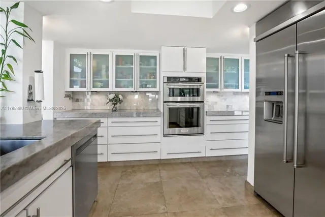 a kitchen with stainless steel appliances cabinets and a counter top space