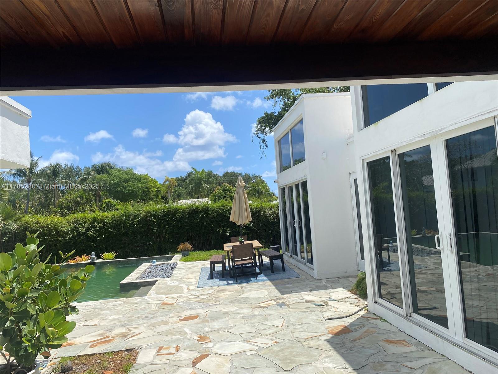 4050 Northeast 25th Avenue Lighthouse Point, FL 33064 - Photo 31 of 35 a view of swimming pool with seating space and fir pit