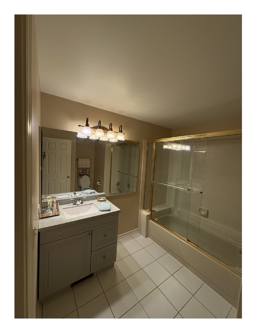 1249 Oak Hill Road, Unit CONDO Lake Barrington, IL 60010 - Photo 3 of 22 a bathroom with a sink mirror and shower
