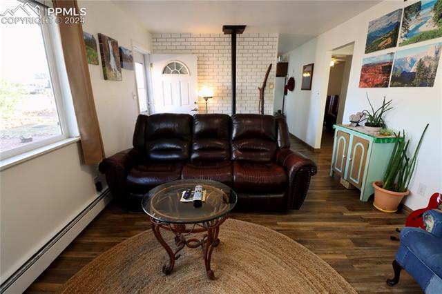 7 Bluff Road Florence, CO 81226 - Photo 15 of 29 Living room featuring baseboard heating and dark wood-type flooring