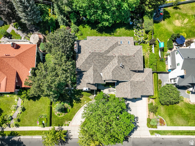 7740 Keswick Road Sandy, UT 84093 - Photo 74 of 74 Multi-gabled roofline with asphalt shingles, featuring extensive tree canopy, a paved driveway, and manicured front and rear lawns
