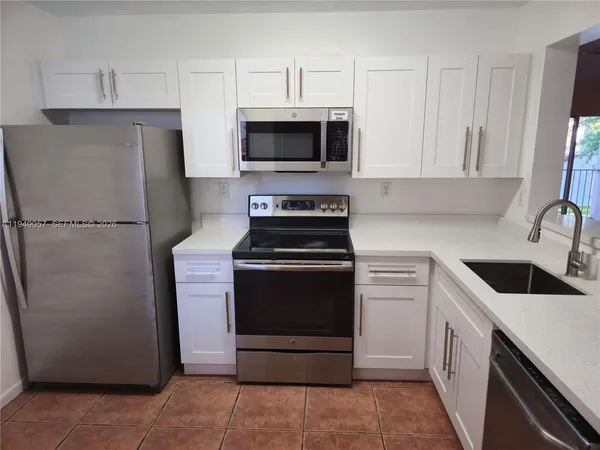 a kitchen with a stove microwave and refrigerator