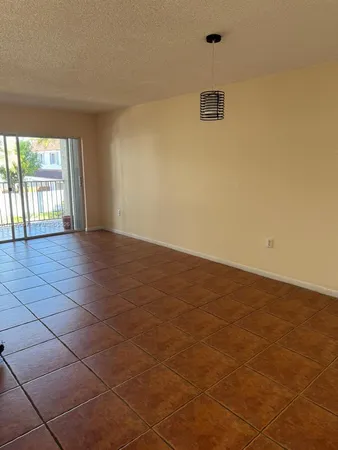 an empty room with a empty space and a window