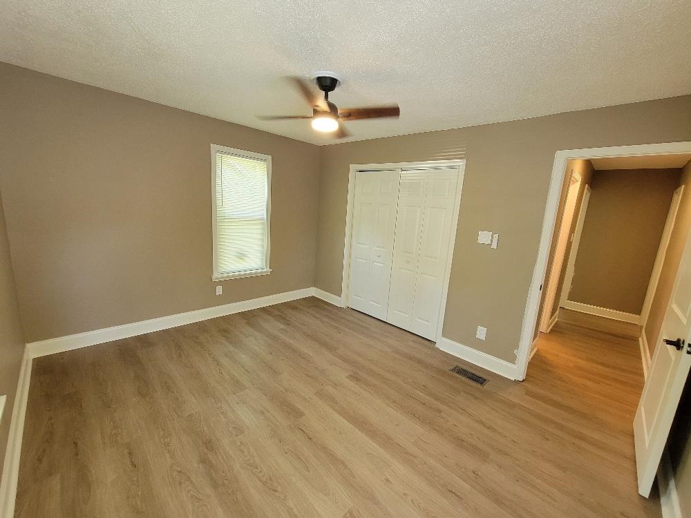 913 Chambliss Road Memphis, TN 38116 - Photo 11 of 16 Room featuring wood-finish flooring, neutral wall tones, and white trim