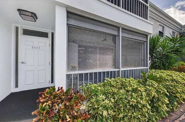 a view of a house with a flower garden