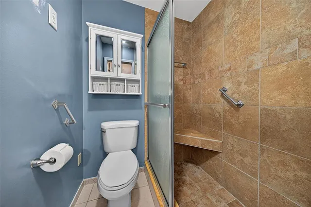 a toilet sitting in a bathroom next to a sink