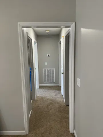 a view of a room with wooden floor and cabinet