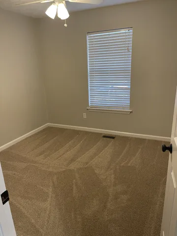 a white toilet sitting next to a bath tub